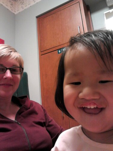 Here's our Glory-girl, playing with the camera while waiting for her turn in the OR.  Love that grin!